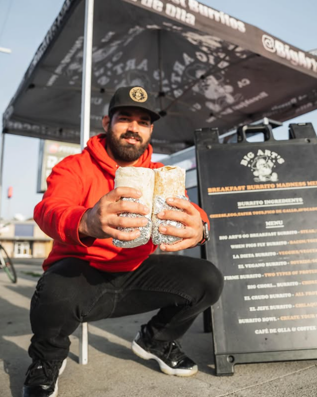 Big Art smiling with fresh burritos